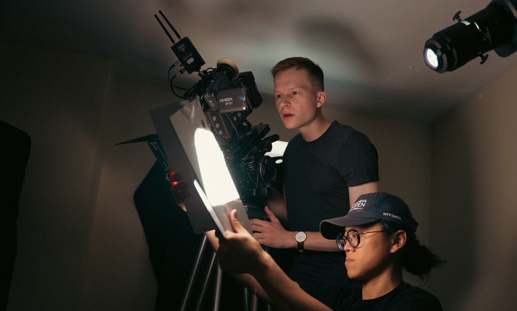 Two men setting up a lighting rig